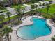 Aerial view of a sparkling community pool with lounge chairs and landscaping, perfect for relaxation and recreation at 1821 Hawks View Dr, Ruskin, FL 33570