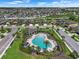 Overhead view of the community pool, surrounded by palm trees and well-manicured landscaping at 1821 Hawks View Dr, Ruskin, FL 33570
