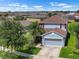 Charming two-story home boasts a well-manicured lawn, mature trees, and a two-car garage at 1821 Hawks View Dr, Ruskin, FL 33570