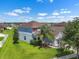 Charming two-story home features a well-manicured lawn, mature trees, and a two-car garage at 1821 Hawks View Dr, Ruskin, FL 33570