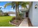 Charming front entrance featuring a walkway, garden bed and a pop of color with flowers at 1821 Hawks View Dr, Ruskin, FL 33570