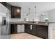 Modern kitchen featuring stainless steel appliances, dark wood cabinets, and granite countertops at 1821 Hawks View Dr, Ruskin, FL 33570