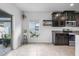 Bright kitchen nook featuring neutral tile floors, plants, and access to the sliding glass door at 1821 Hawks View Dr, Ruskin, FL 33570