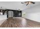 Open concept living room with wood-look floors, a stylish accent wall and an archway to the kitchen at 1821 Hawks View Dr, Ruskin, FL 33570