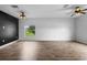 Spacious living room featuring wood-look floors, lots of light and a stylish accent wall at 1821 Hawks View Dr, Ruskin, FL 33570