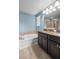 Modern main bathroom with double sinks, soaking tub, and walk-in shower at 1821 Hawks View Dr, Ruskin, FL 33570