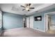 Bright main bedroom featuring a ceiling fan and ensuite bath at 1821 Hawks View Dr, Ruskin, FL 33570