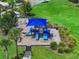 Aerial shot of a colorful community playground with slides, swings, and a shaded play area at 1821 Hawks View Dr, Ruskin, FL 33570
