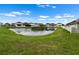 Community view of a pond surrounded by homes at 1821 Hawks View Dr, Ruskin, FL 33570