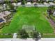 This is an aerial view of the green recreation field, featuring soccer goals and lush landscaping in the community at 1821 Hawks View Dr, Ruskin, FL 33570
