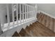 Stairway with white banister and new wood flooring at 1821 Hawks View Dr, Ruskin, FL 33570