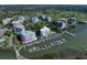 Aerial view showcasing the condos, boat docks, and golf course with a marked unit location at 2 Seaside Ln # 203, Belleair, FL 33756