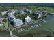 Aerial view of waterfront condos and marina featuring lush landscaping and waterfront access at 2 Seaside Ln # 203, Belleair, FL 33756
