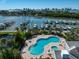 Aerial view of community pool, docks, and waterfront homes with city skyline in the background at 2 Seaside Ln # 203, Belleair, FL 33756
