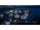Night aerial view of waterfront condos and marina with pool and well-lit surrounding area at 2 Seaside Ln # 203, Belleair, FL 33756