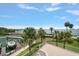 Backyard view features a marina with boat slips and lush tropical landscaping at 2 Seaside Ln # 203, Belleair, FL 33756