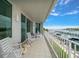 Spacious balcony with comfortable seating, providing panoramic views of the marina and waterfront at 2 Seaside Ln # 203, Belleair, FL 33756