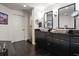 Bathroom featuring double sinks, black cabinetry, and a glass enclosed walk-in shower at 2 Seaside Ln # 203, Belleair, FL 33756
