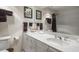 Bathroom featuring white vanity with gold hardware, sink, and large mirror at 2 Seaside Ln # 203, Belleair, FL 33756