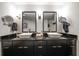 Bathroom featuring double sinks with vessel basins and black cabinetry at 2 Seaside Ln # 203, Belleair, FL 33756