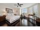 Modern bedroom features a large window, dark wood floors, and a ceiling fan at 2 Seaside Ln # 203, Belleair, FL 33756