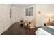 Bedroom with dark wood floors, neutral walls and white trim at 2 Seaside Ln # 203, Belleair, FL 33756