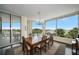 Formal dining room with water view windows and chandelier at 2 Seaside Ln # 203, Belleair, FL 33756