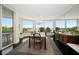 Elegant dining room with a decorative chandelier, large windows with views, and ample seating for gatherings at 2 Seaside Ln # 203, Belleair, FL 33756