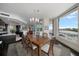 Elegant dining room open to living spaces with large bay view windows at 2 Seaside Ln # 203, Belleair, FL 33756
