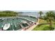 Elevated view of a private boat dock with a boat lift in a waterfront community at 2 Seaside Ln # 203, Belleair, FL 33756