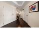 Welcoming foyer with dark hardwood floors and a view into the living room at 2 Seaside Ln # 203, Belleair, FL 33756