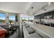 Modern kitchen featuring a long breakfast bar, sleek cabinets, and stainless steel appliances, perfect for cooking at 2 Seaside Ln # 203, Belleair, FL 33756