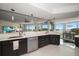 Stylish kitchen with stainless steel appliances, a breakfast bar, and great views of the water and dining room at 2 Seaside Ln # 203, Belleair, FL 33756