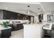 Modern kitchen featuring sleek black cabinets, a large island with seating, and stainless steel appliances at 2 Seaside Ln # 203, Belleair, FL 33756
