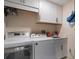 Bright laundry room featuring a modern washer and dryer, and ample storage cabinets at 2 Seaside Ln # 203, Belleair, FL 33756