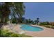 Community pool area with inviting lounge chairs and lush, tropical landscaping at 2 Seaside Ln # 203, Belleair, FL 33756