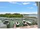 Waterfront docks, boats, and green foliage in the distance at 2 Seaside Ln # 203, Belleair, FL 33756