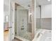 A renovated bathroom features a walk-in shower with glass doors and a soaking tub at 2078 Sunset Point Rd # 83, Clearwater, FL 33765