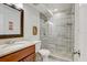 Modern bathroom featuring a glass shower, granite vanity, and stylish fixtures at 2078 Sunset Point Rd # 83, Clearwater, FL 33765