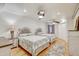Bright bedroom featuring two beds, ceiling fans, and ample natural light from a window at 2078 Sunset Point Rd # 83, Clearwater, FL 33765