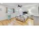 This bedroom features a large bed and wood floors at 2078 Sunset Point Rd # 83, Clearwater, FL 33765
