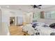 The main bedroom has a view to the bathroom and large windows at 2078 Sunset Point Rd # 83, Clearwater, FL 33765
