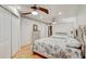 Spacious bedroom with two beds, white walls, and a closet for optimal storage at 2078 Sunset Point Rd # 83, Clearwater, FL 33765