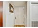 Bright entryway with hardwood floors, white door, and modern mirror at 2078 Sunset Point Rd # 83, Clearwater, FL 33765
