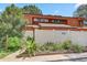 Attractive two-story home with well-maintained landscaping, a fenced yard, and clear street number display at 2078 Sunset Point Rd # 83, Clearwater, FL 33765