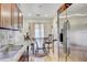 Kitchen with stainless steel refrigerator and breakfast table in the background at 2078 Sunset Point Rd # 83, Clearwater, FL 33765