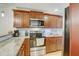 Updated kitchen with stainless steel appliances, granite counters, and wood cabinets at 2078 Sunset Point Rd # 83, Clearwater, FL 33765