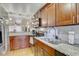 Well-equipped kitchen featuring granite counters, stainless steel appliances, and wood cabinets at 2078 Sunset Point Rd # 83, Clearwater, FL 33765