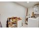 Functional laundry room features a washer, dryer, shelving, and ample storage space for cleaning supplies and essentials at 2078 Sunset Point Rd # 83, Clearwater, FL 33765