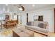 Bright and airy living room showcasing hardwood floors, a modern sofa, and dining area at 2078 Sunset Point Rd # 83, Clearwater, FL 33765